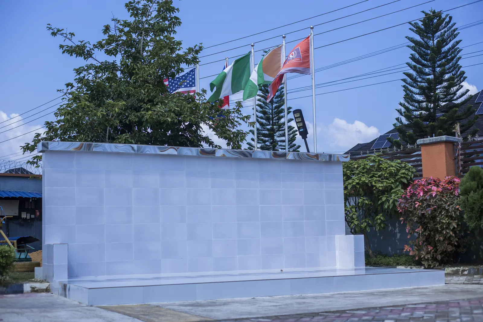 The parade-ground stand and flagpoles on the school grounds