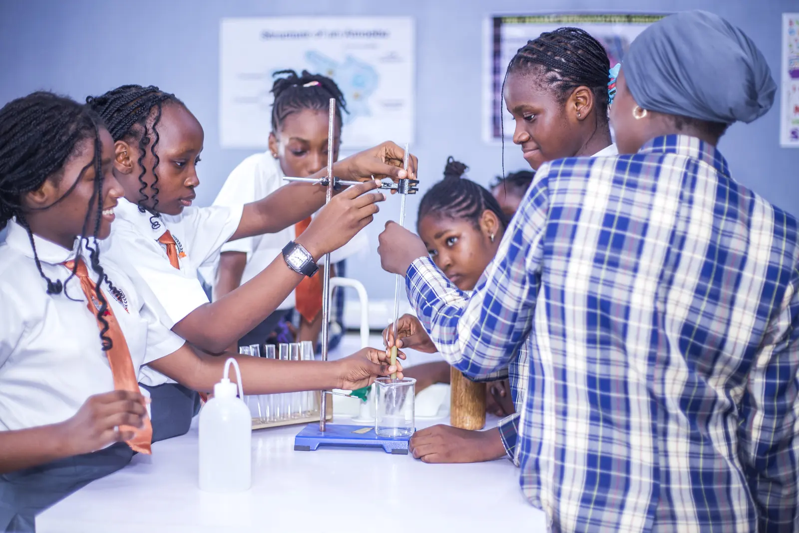 Students carrying out an experiment with test tubes in the science laboratory
