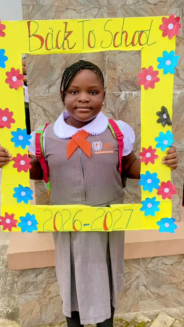 A pupil holding a “Back to School 2026–2027” photo frame on the first day of term