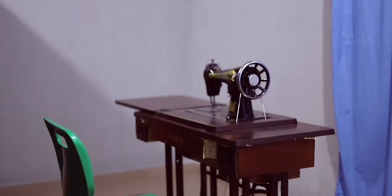 A sewing machine on its table in the trade-learning room